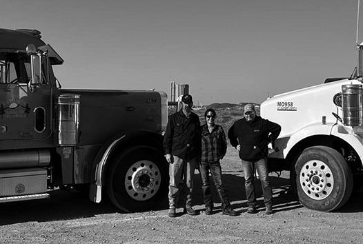 Freddie and Shauna Gentry (left) along with Garrett Romelle with trucks from S&amp;amp;F Trucking and Mann Energy used to gather relief supplies donated from across North Dakota. Freddie and Shauna were bound for North Carolina on Oct. 21. Photo submitted by Shauna Gentry.