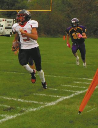 Mason Pollestad sprints down the sideline for a successful touchdown drive. Photo by Jamie Rarick