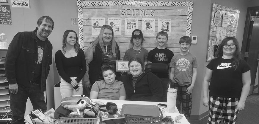 Osowski and her sixth grade class pose for a photo before their pizza party.
