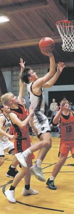 Making it past a strong Tornado defense, Titan Teddy Otto moves in for the layup Jan. 9. Photo by Jamie Rarick