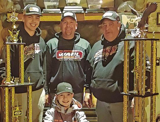 Hunter Johnson with his trophies. Pictured left to right: Jaden Haagenson, Scott Johnson, Hunter Johnson (front), and Gerry Beauchamp. Photo submitted by Johnson Racing
