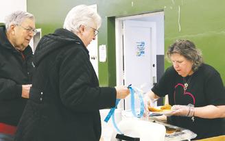Meridith Gozdal serves Ray and Judy Gozdal at the benefit for Brandon Patterson on Saturday. Photo by Lyle Van Camp.