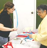 Ally VanCamp sells Louise Long some tickets for the silent auction. Photo by Lyle Van Camp.