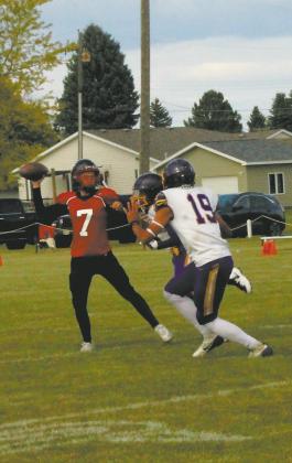 Under pressure, Max Foss-Pokrzywinski looks to pass over Eagle defenders. Photo by Jamie Rarick