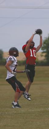 Leaping in the air, Bomber freshman Shawn Patterson intercepts the ball for a turnover. Photo by Jamie Rarick