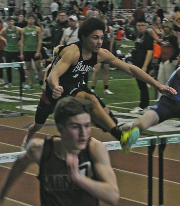 Titan sophomore Mason Pollestad clears the hurdle in the Boys 60M Hurdles. Pollestad secured a place in the finals, placing 5th with a new personal record. Photo by Jamie Rarick