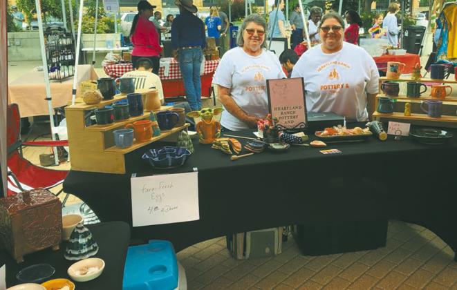 Elizabeth Linster and her sister, Sherry selling Heartland Ranch Pottery at a street fair. Submitted photo.