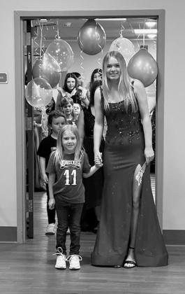 Young ladies from North Border School were escorted by Mrs. Longtin’s kindergarten class to show off their dresses at PNC prom. Submitted photo.