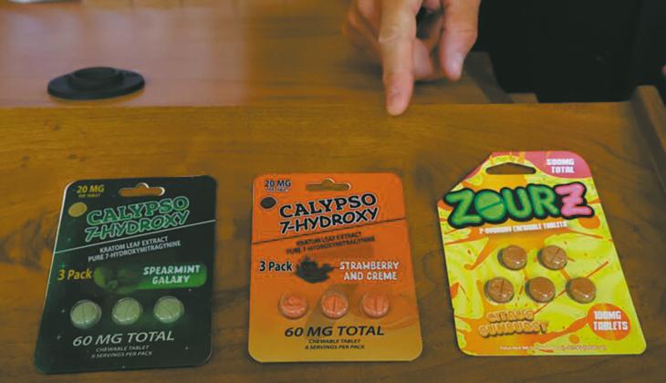North Dakota Attorney General Drew Wrigley points at three packages of 7-OH tablets, a concentrated synthetic extract of kratom, after a press conference where Gov. Kelly Armstrong announced actions to restrict kratom in North Dakota on Aug. 3, 2026. (Photo by Michael Achterling/North Dakota Monitor)
