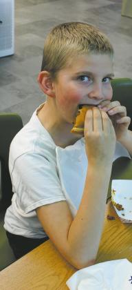 Caleb Rarick enjoys a barbecue served by Drayon FCCLA. Photo by Jamie Rarick