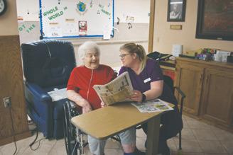 Heather Ahrendt (Nursing Dept. Scheduler and Med Tech) and Florence Mitzel (Resident). Photo by Levi Jones, News Monitor.