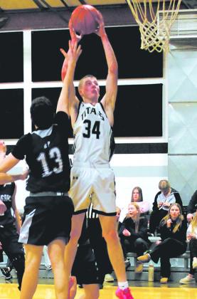 DVE junior Jack Langerud secures the rebound over North Prairie junior Julius Elick. Photo by Jamie Rarick.