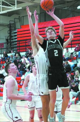 Quinn Passa lays in a left hand layup against the Cards. Photo by Larry Stokke