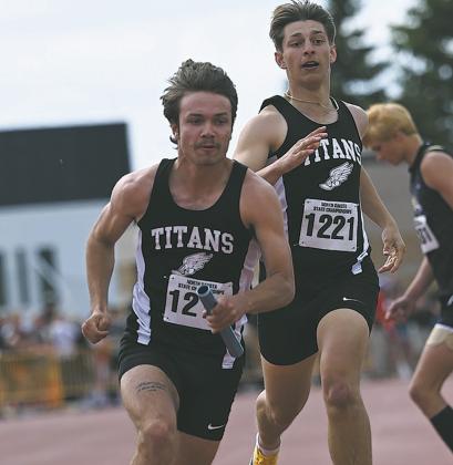 Trenten Bronson-Keena took off once he had the baton from Carter Johnson during the 4X100 relay. Photo by Ashley Schafer