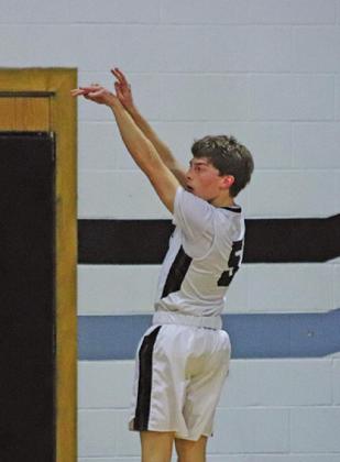 Sam Johnson puts up a three early in the game against the Larimore Polar Bears. VNV Photo by Lesa Van Camp