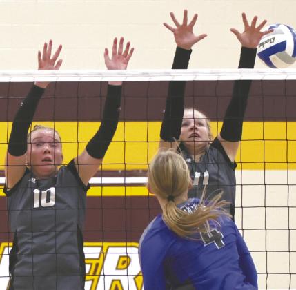 Easton Larson and Violet Hoyles block a H-VC kill attempt. Photo by Lyle Van Camp