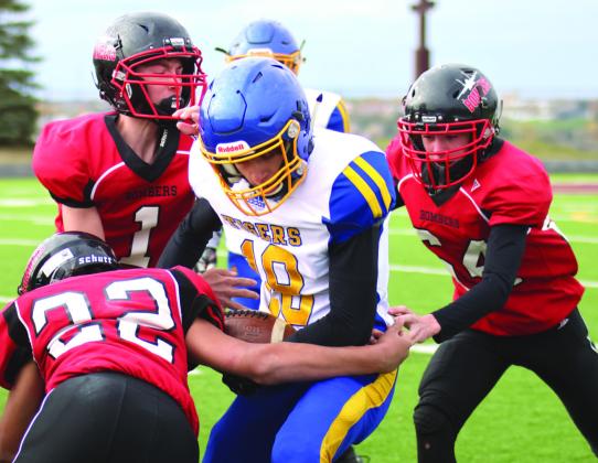 Lucas DeSouza, Jonah Rarick, and Landon Mapel team up to stop Trenton’s Maddix Longie on one of the last plays of the game.