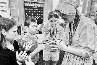 Students play ‘cat's cradle,’ a game in which a loop of string is put around and between the fingers, creating complex patterns.
