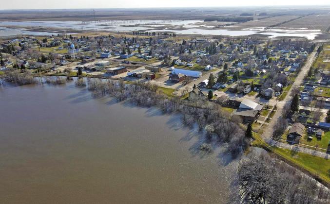 Drone flood picture taken by Travis Uggerud last Wednesday while patrolling the dikes in Drayton shows the town looking slightly like an island just before the river reached its crest last week.