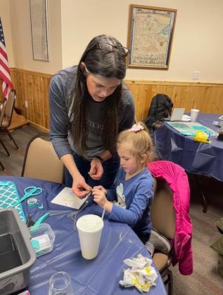 Christine Sibilleau, Independent Chalk Couture Designer, Roseau, Minn., helps with a project during the Riverfest event in Drayton over the weekend. Photos by Jessica M. Woinarowicz.