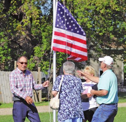 David Kirkeby’s siblings raise the flag in his memory last Wednesday morning. VNV Photo by Lesa Van Camp