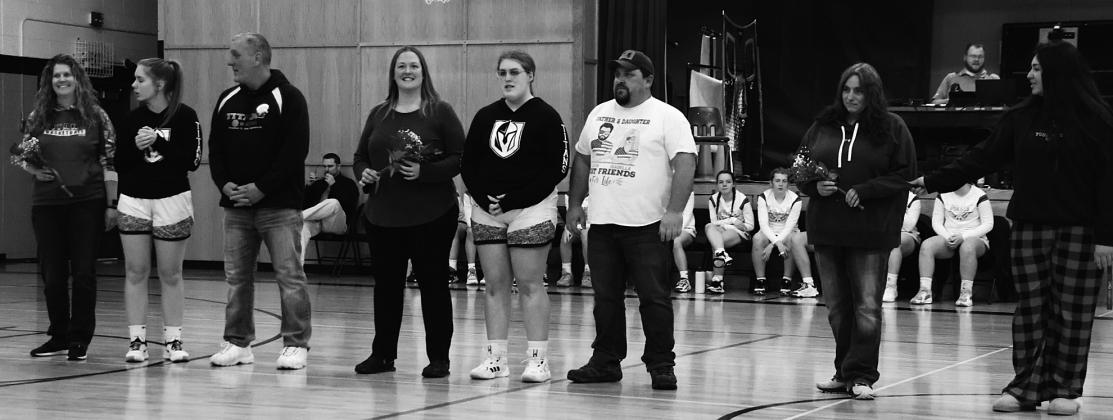 Seniors and their parents on Senior Night. From the left; Jessie Aasand, Kira Aasand, Mike Aasand, Andrea Douville, Isabella Douville, Justin Douville, Lacey Wherley, and Trinity Wherley. Photo by Lyle Van Camp.