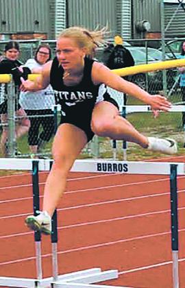 Reese Fering clears the hurdles, placing 4th in the girls 100 hurdle competition. Photo by Jamie Rarick