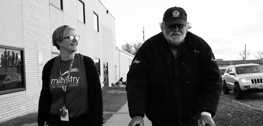 Michael Hauck, a homeless veteran, walks next to his behavioral health manager before being transported to a nearby hotel as he awaits approval to move into a nearby apartment. (Photo by Michael Achterling/North Dakota Monitor)
