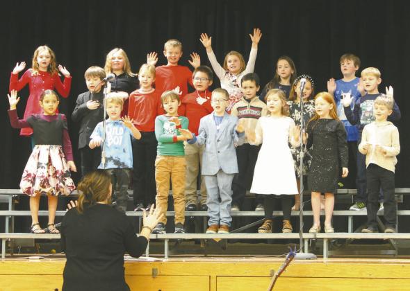 Grades one and two included some fun actions during singing at the winter program on Friday morning. Photo by Jamie Rarick