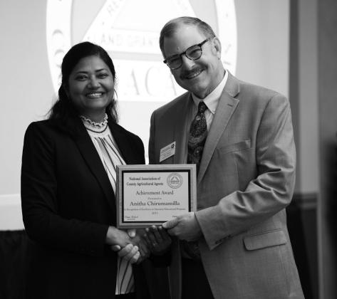 Anitha Chirumamilla, Extension cropping systems specialist at the NDSU Langdon Research Extension Center, receives the National Achievement Award at the National Association of County Agricultural Agents conference. (NDSU photo)