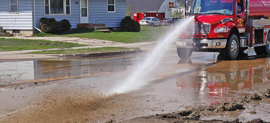 The Drayton Volunteer Fire Department water truck was used to clean mud from the street following the repairs. VNV Photo by Lesa Van Camp