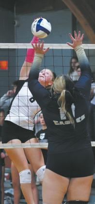 DVE sophmore Peyton Larson slams the ball towards North Border senior Jaelyn Forrey. Photo by Larry Stokke.
