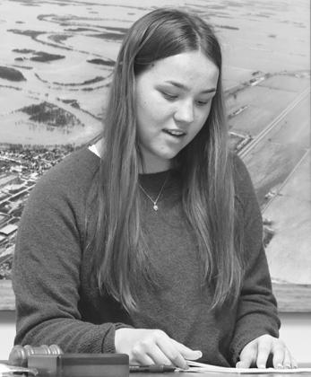 Outgoing National Honor Society President Hailey Berg calls the meeting to order.
