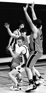 Connor Hurtt looks for an open teammate in action against Larimore. Photo by Lyle Van Camp.