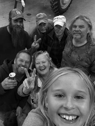 Aurora Jensen in front with Gary Jensen and SuZanne Risberg-Elliott behind. Back row (L-R) Danny Coleman, Mark Elliott, Denny Hill, and Bruce Martinson. Not pictured: Josh Coleman, Kari Jo Jensen and boys, Trapper and Hawkin.