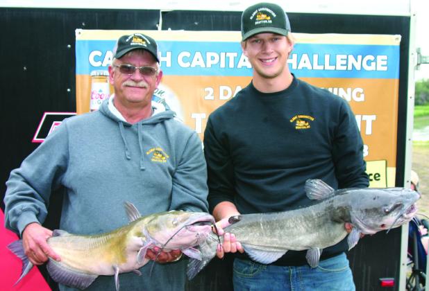 Jeff and Thomas Blawat of Drayton pose with their catches of the day. Photo by Rob Boll.