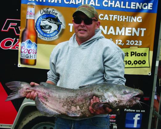 Chris Dolan poses with the second biggest fish caught in the tournament at 24 pounds. Photo by Rob Boll.