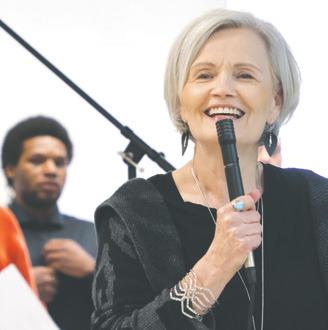 Cheryl Gjevre introducing the choir at the Adult and Teen Challenge event Sunday. Photo by Lyle Van Camp.