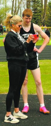 Coach Jodi Fedje reviews video with Jack Langerud between attempts in the mens high jump competition. - Photo by Jamie Rarick.