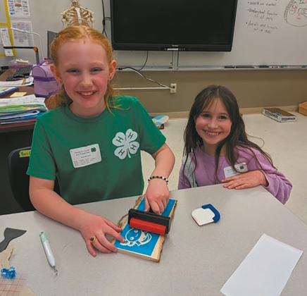 Ava and Olive personalize their signs in the sign etching class. Submitted photo