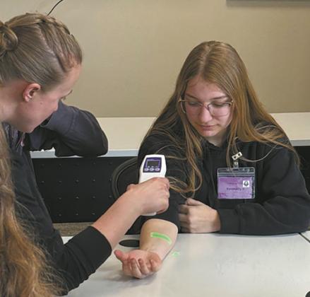 A vein finder is demonstrated on Kennedy Osowski during Scrubs Camp. Submitted photo.