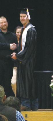Ryan Corrick looked back at the crowd as he accepted his diploma. Photo by Andrea Johnston