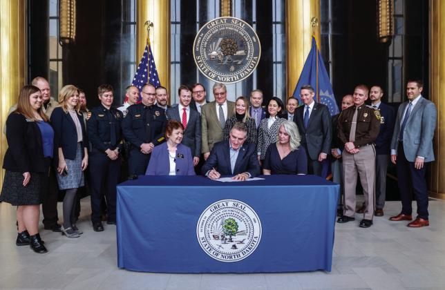 Gov. Doug Burgum signs House Bill 1307 and other ‘Back the Blue’ bills on April 18, 2023. HB 1307 provides $3.5 million in grants for recruitment, retention and training tuition through mid-2025 to police departments across the state. Photo provided by the Office of the Governor.