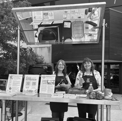Julie Garden-Robinson, NDSU Extension food and nutrition specialist, and Beth Dahl, grant coordinator, share a cooking demo at the Red River Market. (NDSU photo)