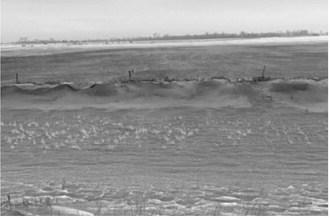 A roadside ditch along Highway 2, about 5 miles west of Grand Forks, North Dakota, full of topsoil from the adjoining field that was tilled in fall on Dec. 19, 2021.