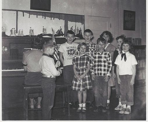 Clint holding American flag at District 13 school in 1955. Submitted photo