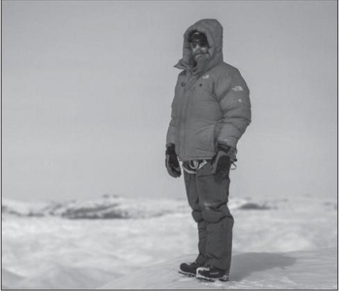 Dr. Jon Solberg surveys a field of crevasses during the E7 Greenland expedition. Photo by Scott Brady, a member of the expedition.