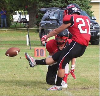 Hunter Johnson kicks for the two points after a Bombers touchdown against New Town Saturday. All photos by Lyle Van Camp