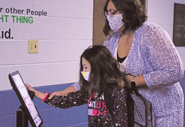 The new normal Ms. Lindsay Pollestad helps Gianna Sott take her temperature after entering school Tuesday Morning. VNV Photo by Lesa Van Camp