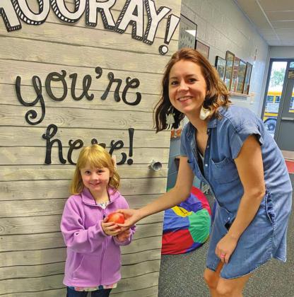 Suttyn Halvorson brings Mrs. Schumacher an apple for the first day of school. Photo submitted